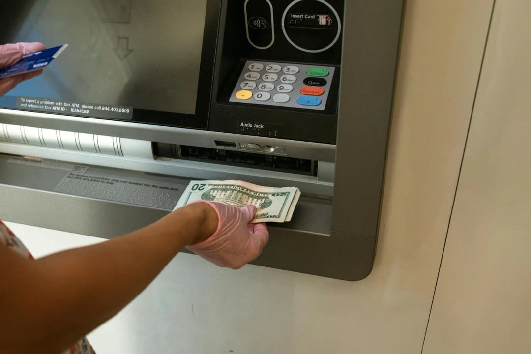 Person withdrawing money from an ATM in Poland