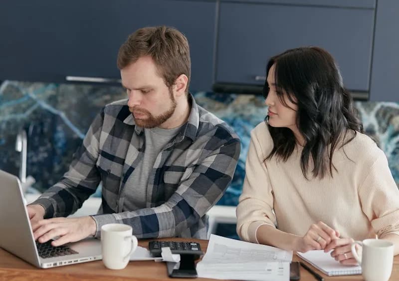 Couple planning their monthly budget for living in Poland