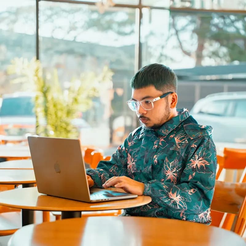Remote worker at a laptop in a cafe